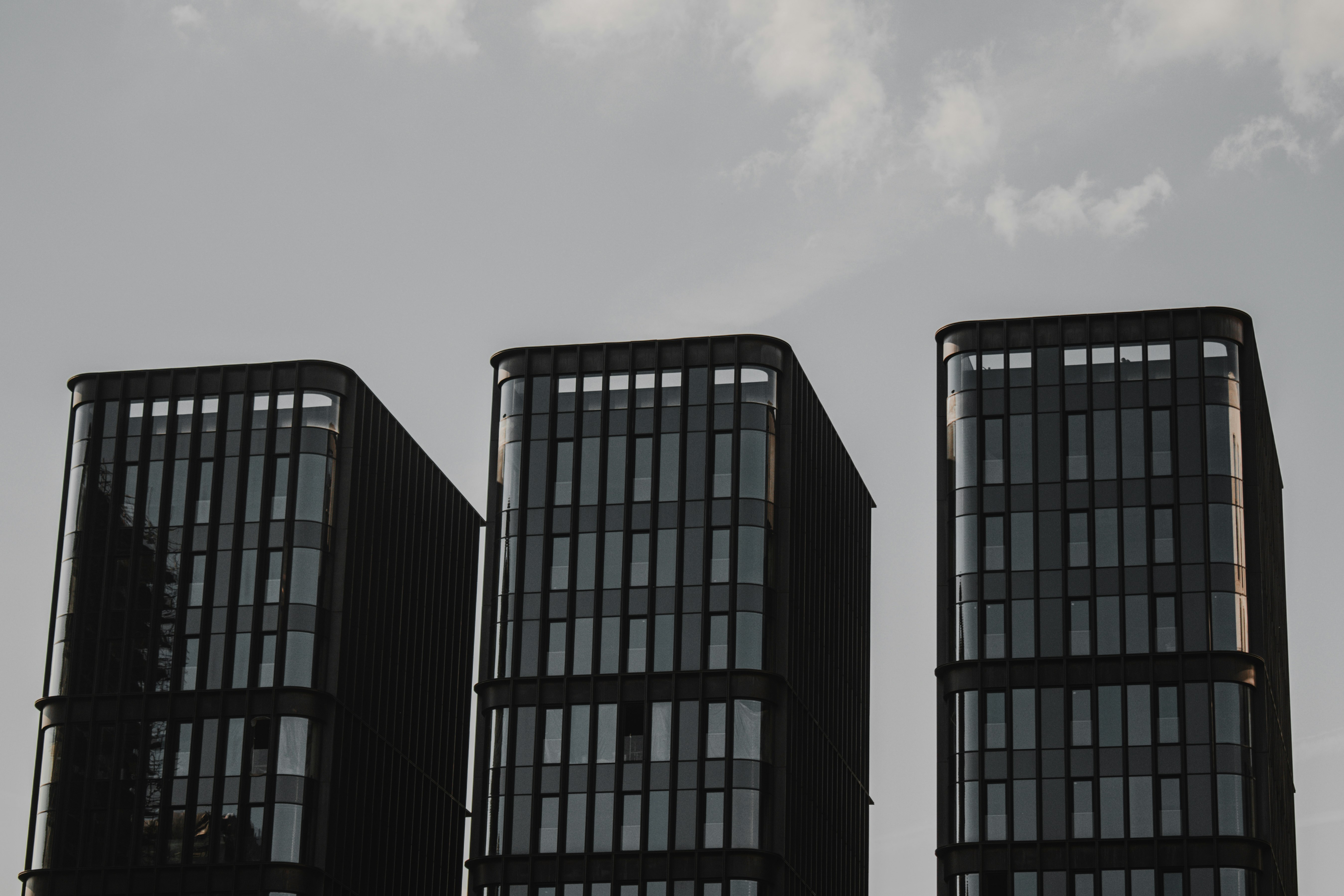 blue and black building under white clouds during daytime